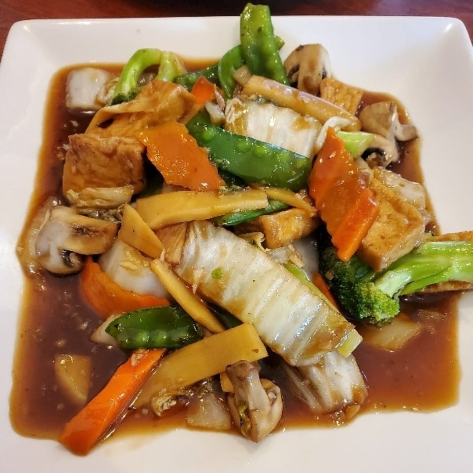 Vietnamese stir-fried vegetables with tofu, mushrooms, carrots, and broccoli in a savory sauce.
